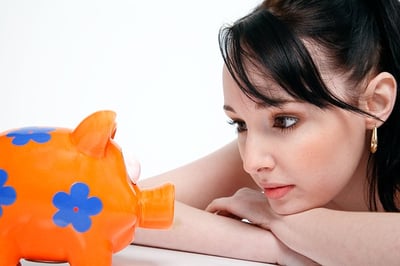 body-woman-looking-at-piggy-bank