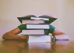 body_student_pile_of_books.jpg