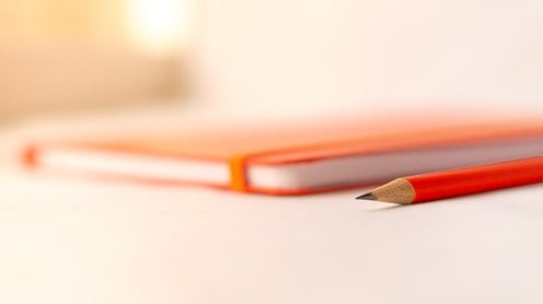 feature_orange_notebook_pencil_college_essay_topics