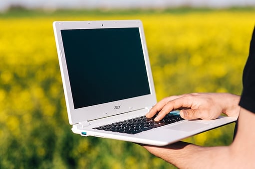 feature_person_holding_laptop_outside